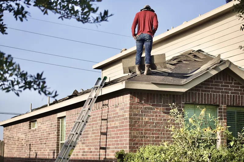 Professional roofer working on a residential roof in Winston Park